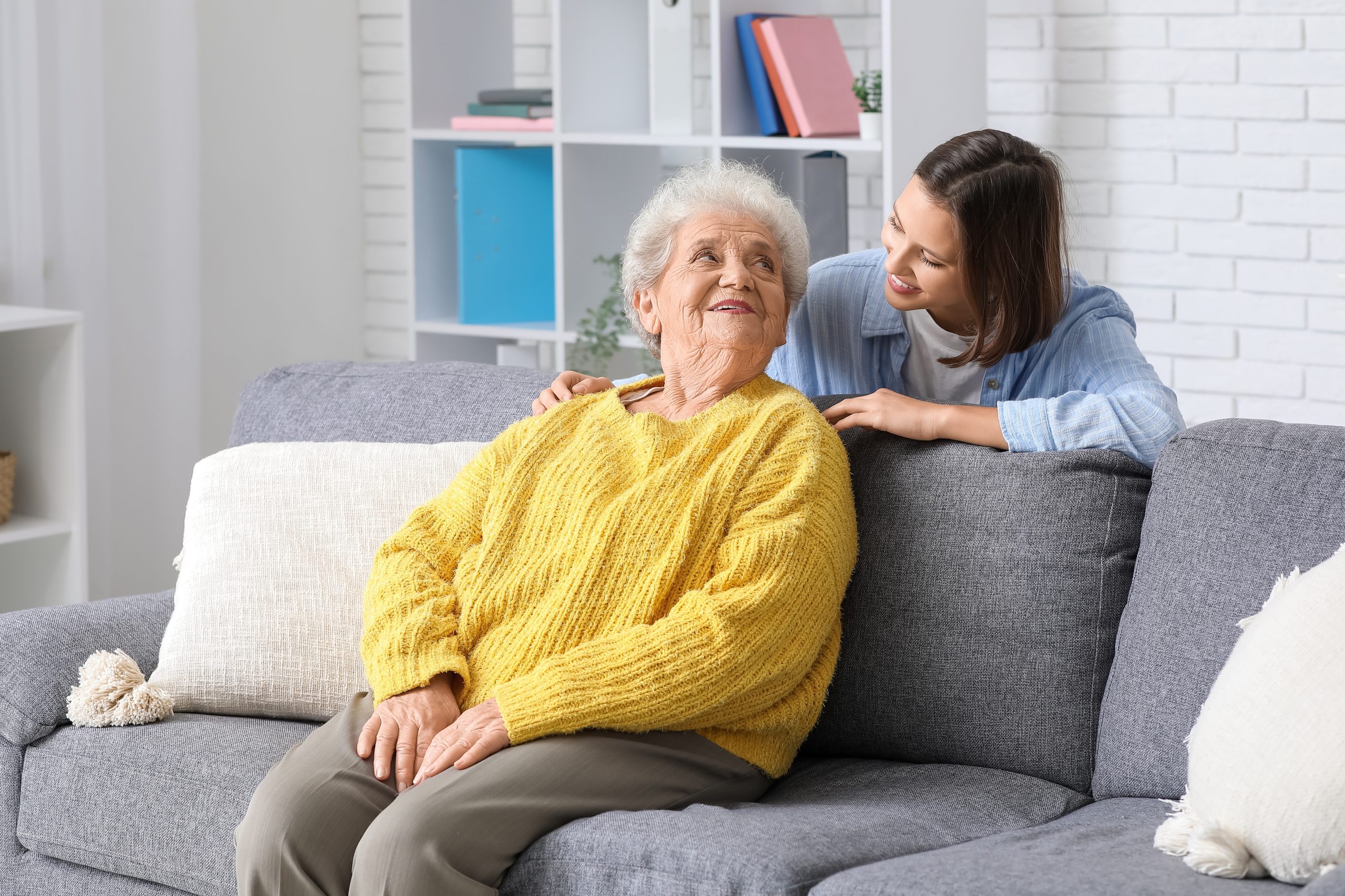 Caregiver and elderly person enjoying quality time at home