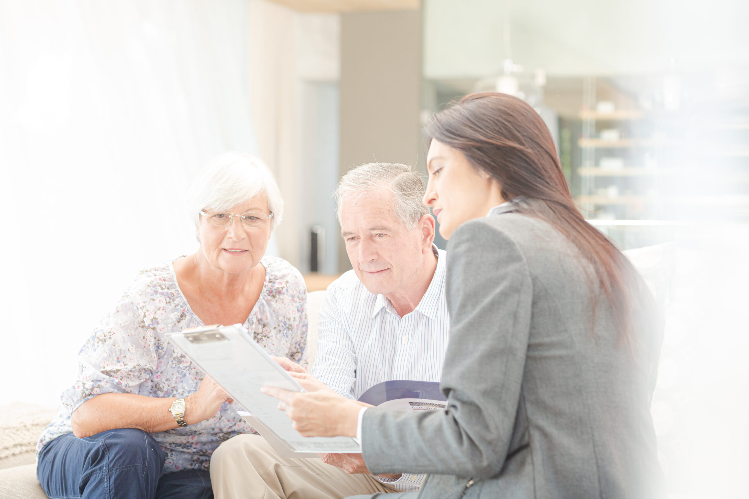 Senior couple reviewing in-home care cost options with a caregiver consultant