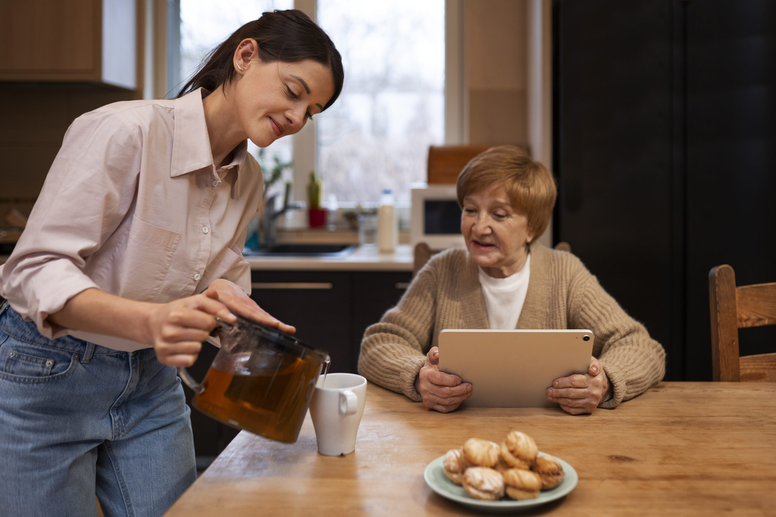 Caregiver pouring coffee for a senior client
